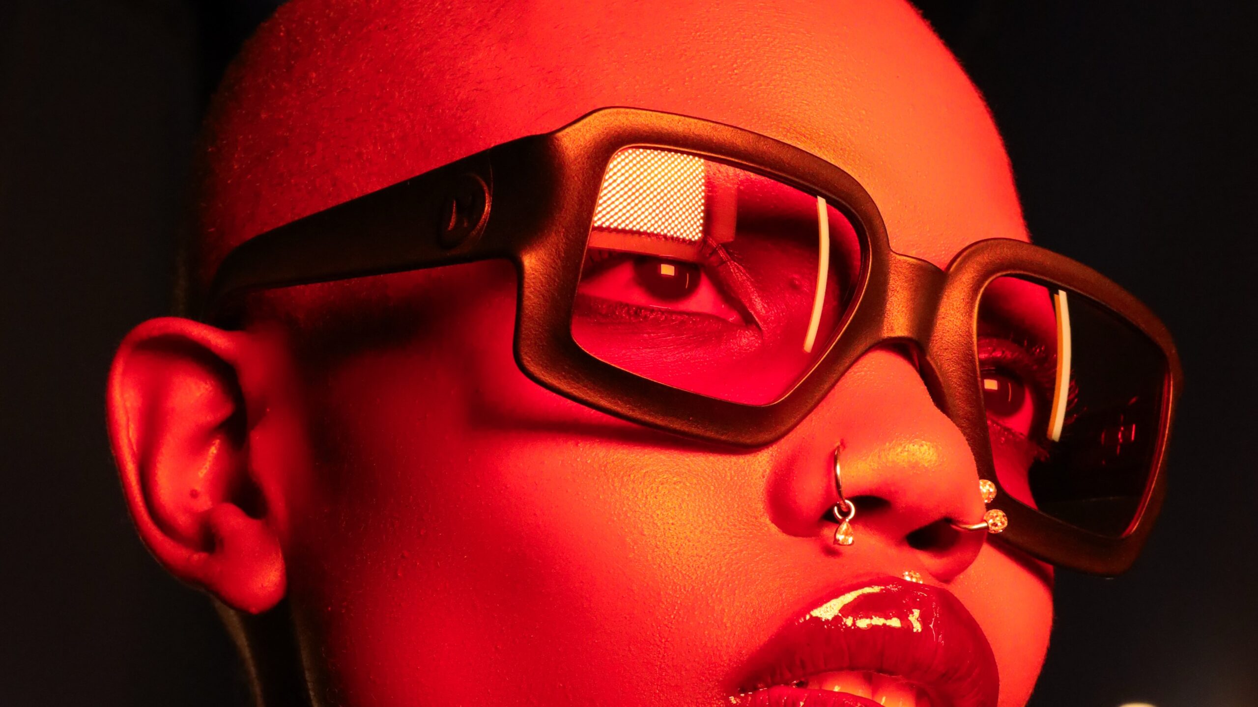 Close-up portrait highlighting REFRAMD Afronaut Eclipse parametric eyewear with bold geometric frame