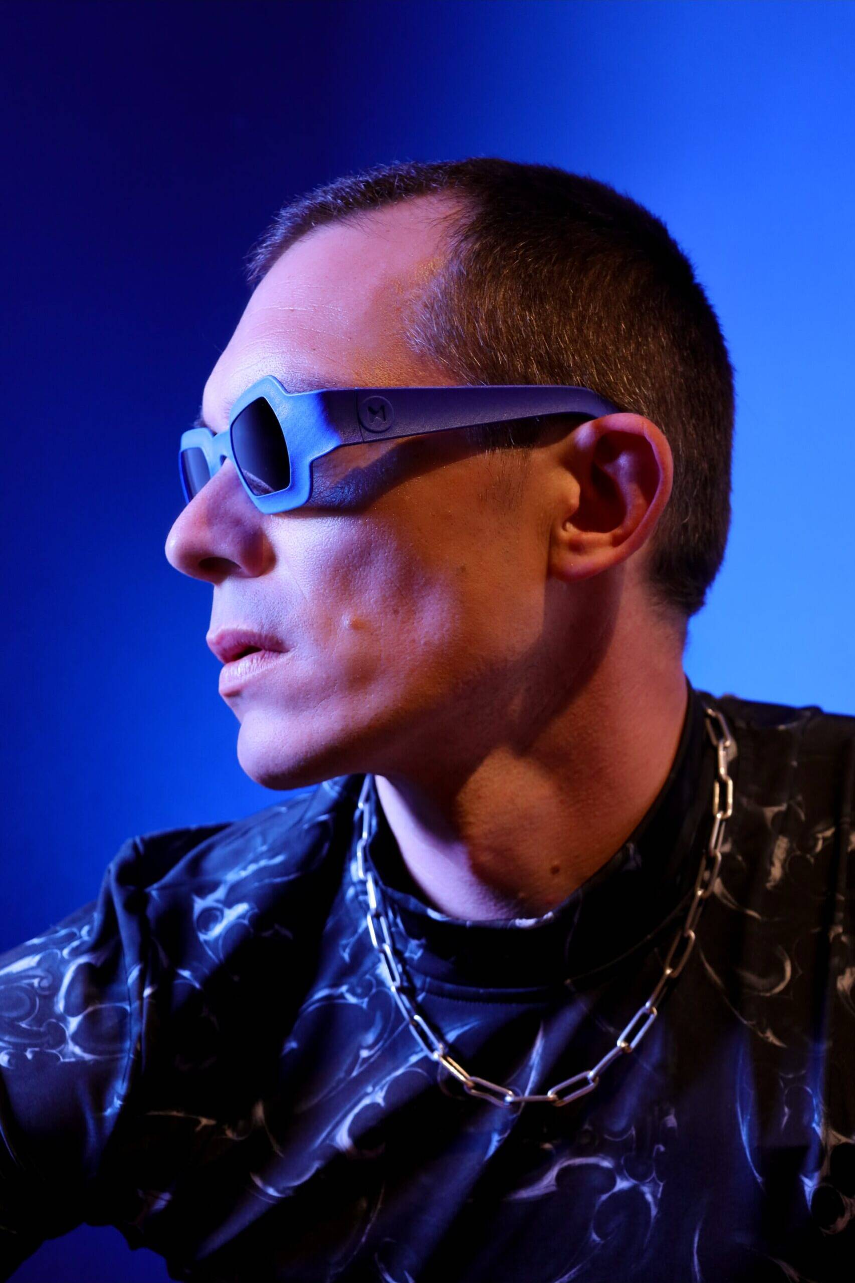 Side portrait showing REFRAMD Afronaut computationally designed sunglasses and sculpted temple geometry